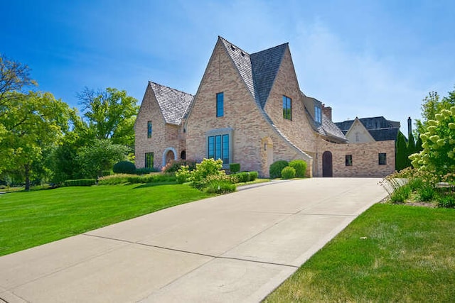 31 Concord Dr, Oak Brook, IL 60523 - view of front of house featuring driveway, stone siding, and a front yard