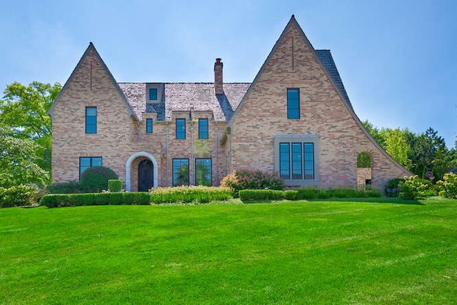 31 Concord Dr, Oak Brook, IL 60523 - english style home with a front lawn, a chimney, and brick siding