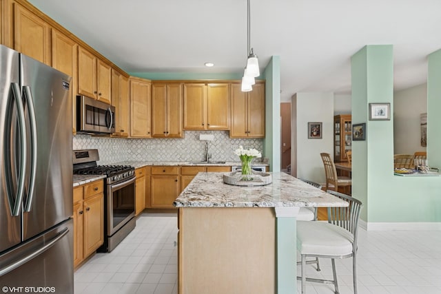 kitchen with appliances with stainless steel finishes, backsplash, light stone countertops, a sink, and recessed lighting