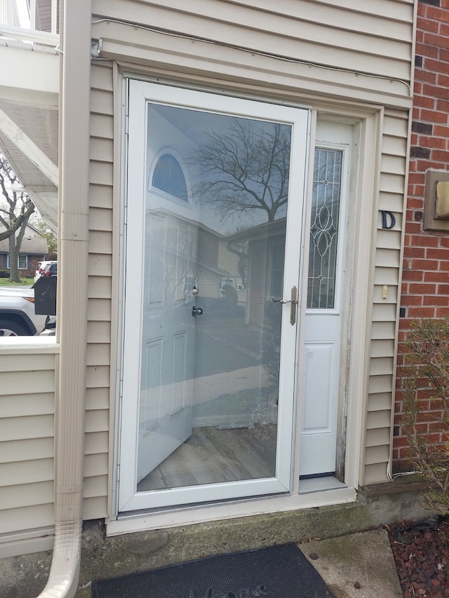 doorway to property with brick siding