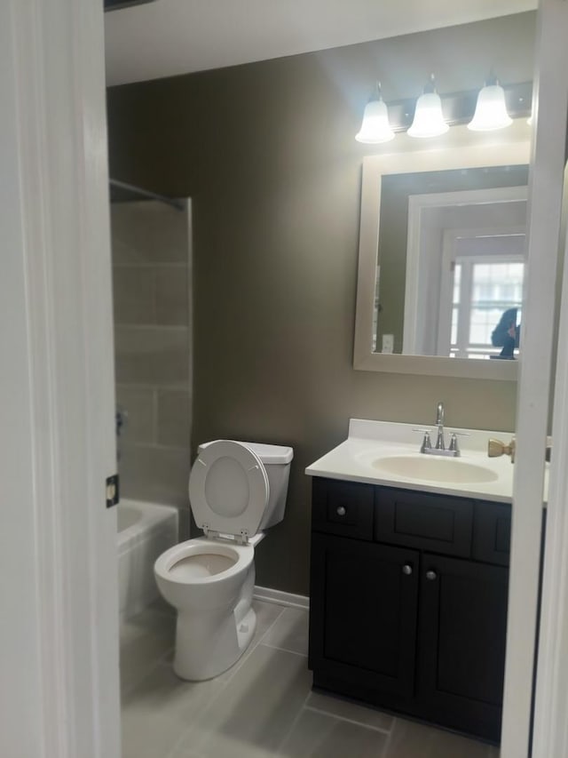 full bath featuring toilet, vanity, tile patterned flooring, shower / washtub combination, and baseboards