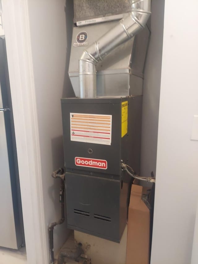utility room featuring heating unit