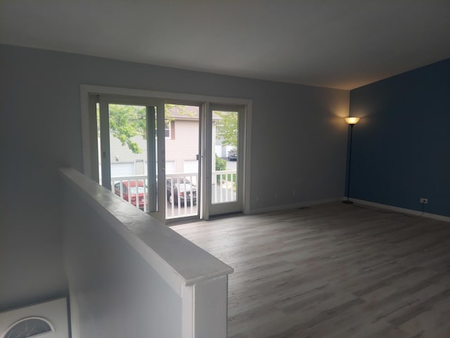 unfurnished room with wood finished floors and baseboards