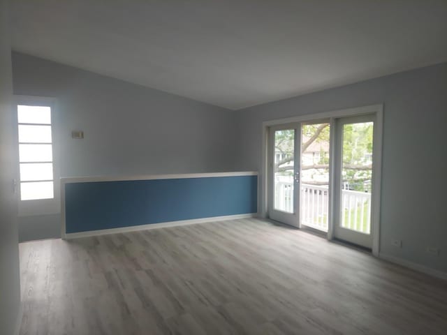 spare room with wood finished floors and baseboards