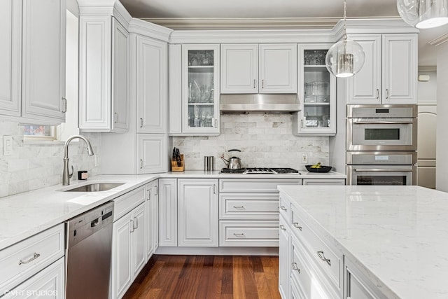4845 N Bell Ave, Chicago, IL 60625 - kitchen featuring appliances with stainless steel finishes, a sink, under cabinet range hood, and white cabinets