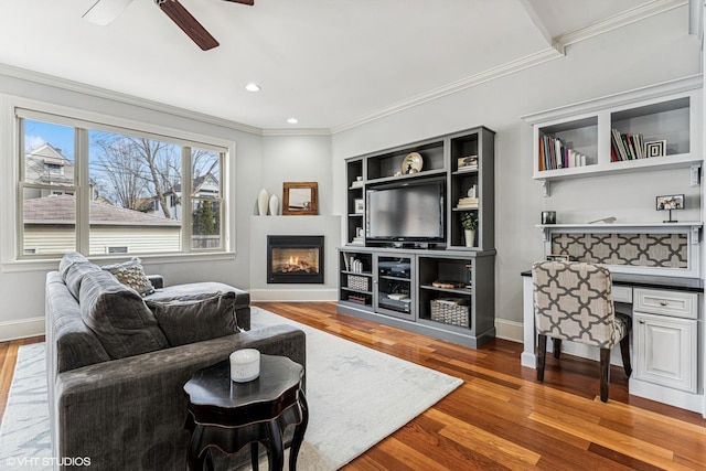 4845 N Bell Ave, Chicago, IL 60625 - living area with crown molding, wood finished floors, a glass covered fireplace, a ceiling fan, and baseboards