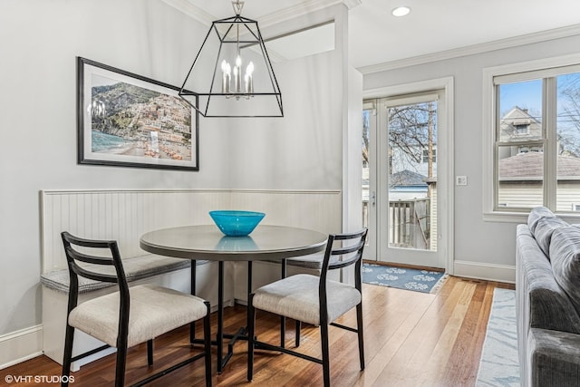 4845 N Bell Ave, Chicago, IL 60625 - dining room featuring a chandelier, wood finished floors, ornamental molding, wainscoting, and baseboards