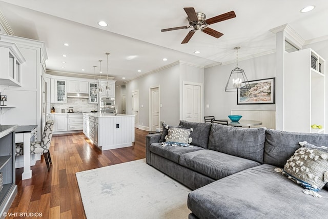 4845 N Bell Ave, Chicago, IL 60625 - living room with ornamental molding, dark wood-style flooring, a ceiling fan, recessed lighting, and a chandelier