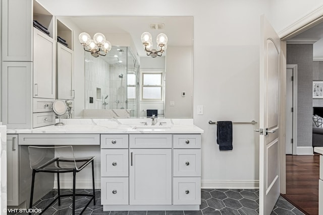 4845 N Bell Ave, Chicago, IL 60625 - bathroom featuring a chandelier, a shower stall, vanity, baseboards, and tile patterned flooring