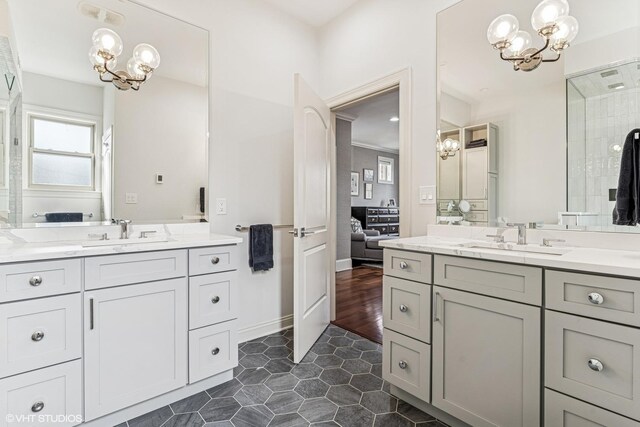 4845 N Bell Ave, Chicago, IL 60625 - ensuite bathroom featuring a chandelier, two vanities, and tile patterned floors