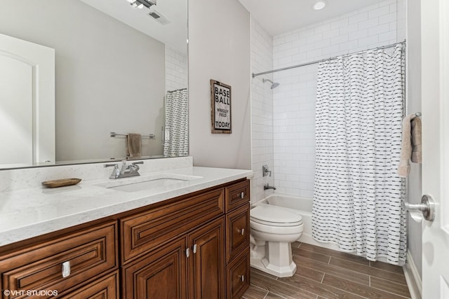 4845 N Bell Ave, Chicago, IL 60625 - bathroom featuring toilet, shower / bath combo with shower curtain, vanity, and wood tiled floors