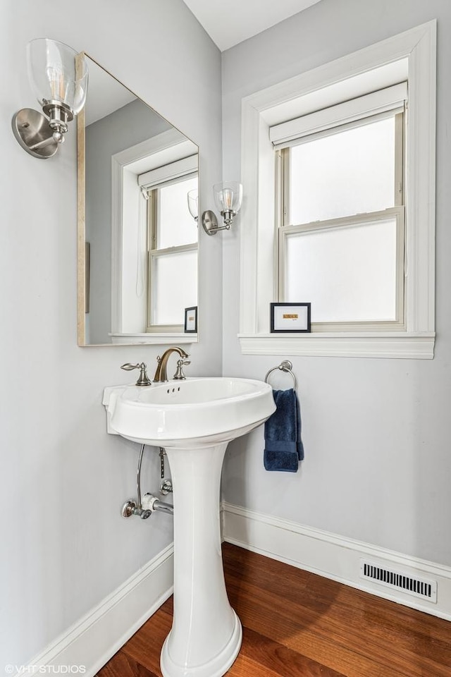 4845 N Bell Ave, Chicago, IL 60625 - bathroom with baseboards and wood finished floors