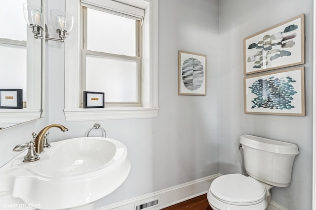 4845 N Bell Ave, Chicago, IL 60625 - bathroom with baseboards, a sink, and toilet