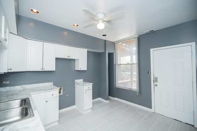 3929 W Arthington St, Chicago, IL 60624 - kitchen with ceiling fan, white cabinetry, light stone counters, and recessed lighting