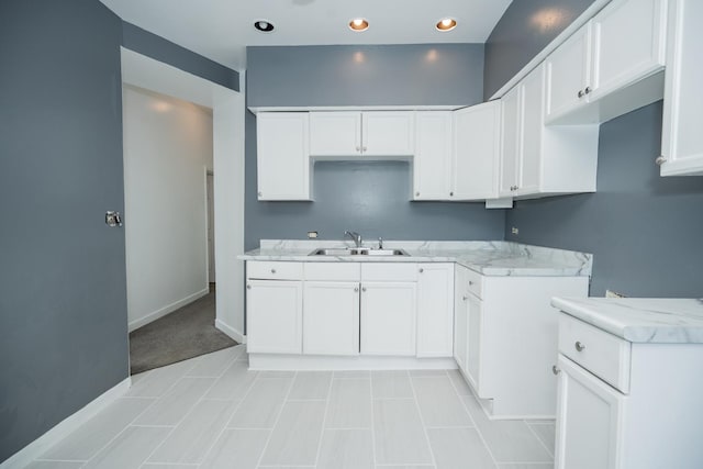 3929 W Arthington St, Chicago, IL 60624 - kitchen with a sink, white cabinets, baseboards, and recessed lighting