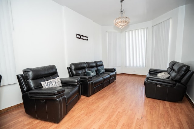 3929 W Arthington St, Chicago, IL 60624 - living area featuring a chandelier, wood finished floors, and baseboards
