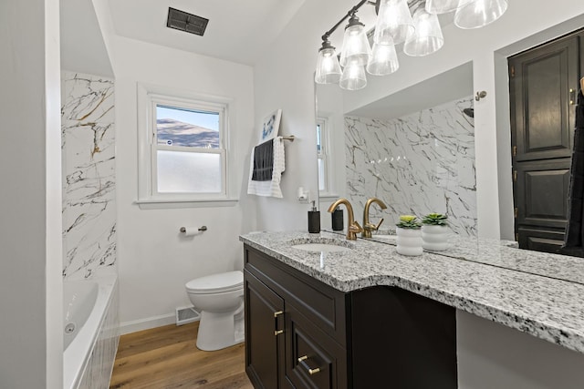 785 E 164th St, South Holland, IL 60473 - full bath featuring a tub to relax in, toilet, vanity, wood finished floors, and a shower