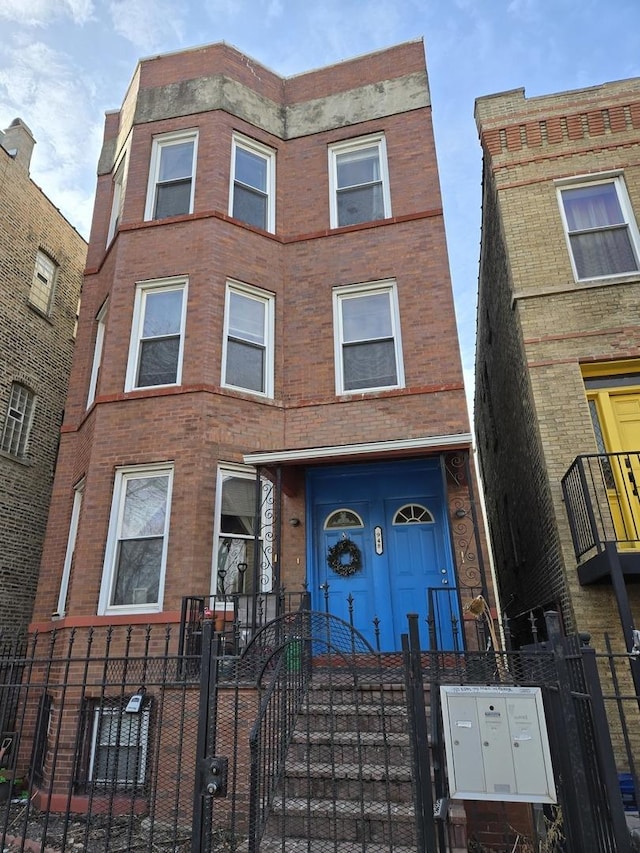 948 N California Ave, Chicago, IL 60622 - multi unit property featuring a fenced front yard, brick siding, and a gate