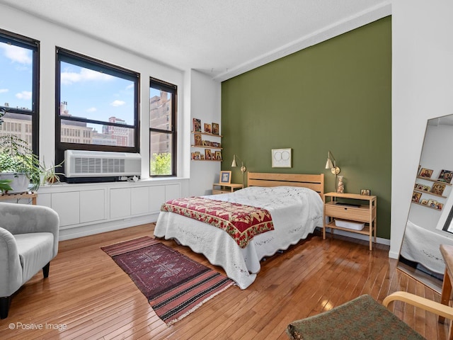 600 S Dearborn St Unit 302, Chicago, IL 60605 - bedroom with wood-type flooring, a textured ceiling, and cooling unit