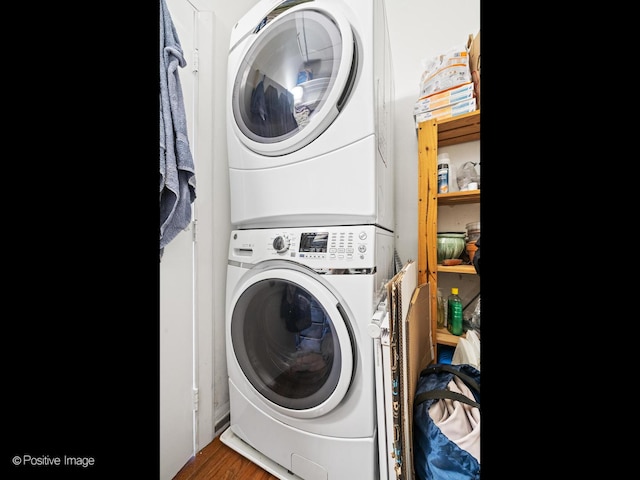 600 S Dearborn St Unit 302, Chicago, IL 60605 - washroom featuring stacked washer / dryer and wood finished floors