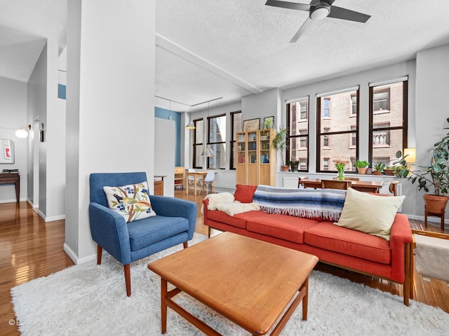 600 S Dearborn St Unit 302, Chicago, IL 60605 - living room with a textured ceiling, wood finished floors, a ceiling fan, and baseboards