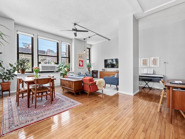 600 S Dearborn St Unit 302, Chicago, IL 60605 - living room featuring light wood-style floors, ceiling fan, a textured ceiling, and baseboards