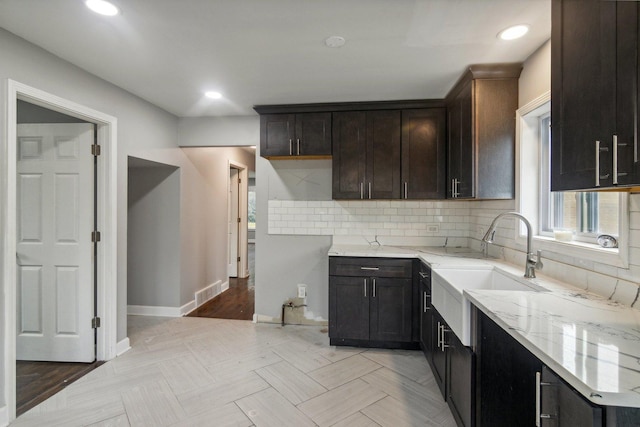 15123 Wabash Ave, South Holland, IL 60473 - kitchen with light stone countertops, a sink, tasteful backsplash, dark brown cabinets, and recessed lighting
