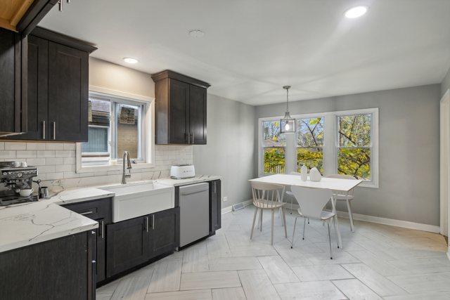 15123 Wabash Ave, South Holland, IL 60473 - kitchen featuring a sink, white dishwasher, baseboards, tasteful backsplash, and healthy amount of natural light