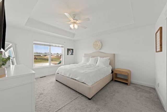 2319 Coventry Cir, Sycamore, IL 60178 - bedroom featuring a raised ceiling, baseboards, light carpet, and a ceiling fan