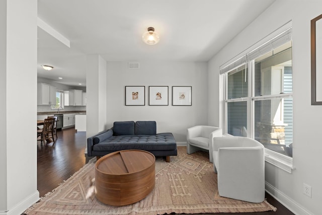 2319 Coventry Cir, Sycamore, IL 60178 - living room featuring dark wood-style flooring and baseboards