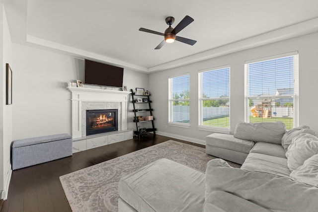 2319 Coventry Cir, Sycamore, IL 60178 - living room with a tray ceiling, a fireplace, ceiling fan, and baseboards