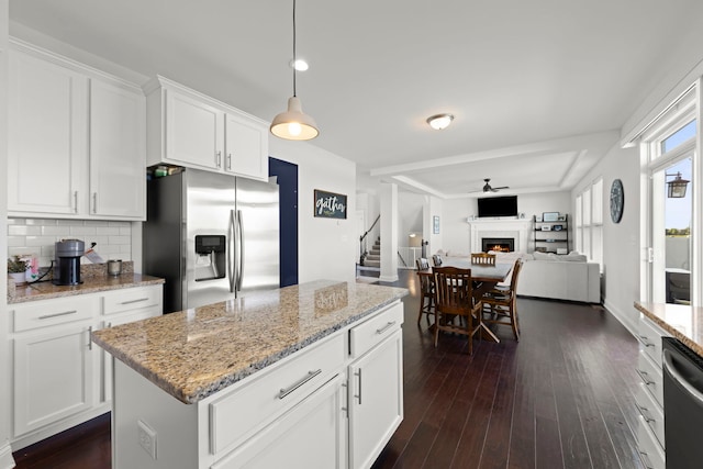 2319 Coventry Cir, Sycamore, IL 60178 - kitchen with appliances with stainless steel finishes, dark wood-type flooring, a lit fireplace, and decorative backsplash