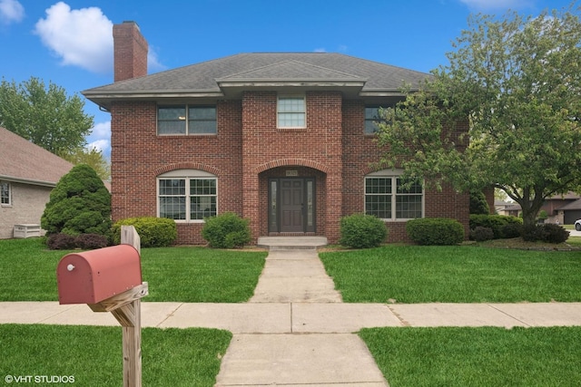 18321 Country Ln, Lansing, IL 60438 - view of front of house featuring a chimney, a front lawn, and brick siding