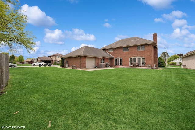 18321 Country Ln, Lansing, IL 60438 - back of property featuring a chimney, a garage, a lawn, brick siding, and a patio area