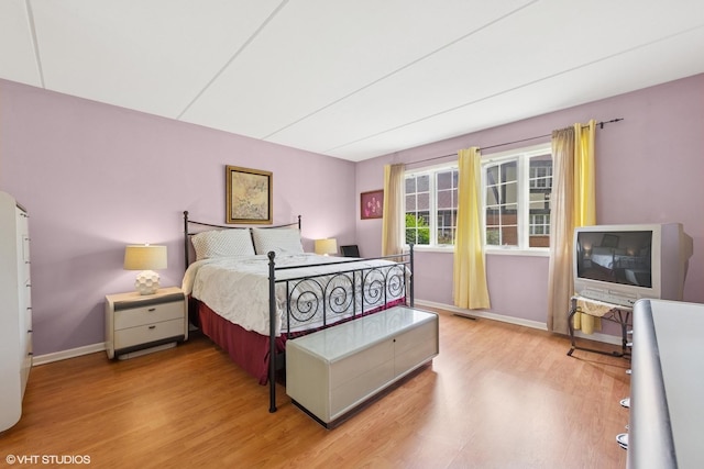 bedroom with wood finished floors and baseboards
