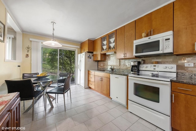 kitchen with white appliances, decorative backsplash, brown cabinetry, hanging light fixtures, and ornamental molding