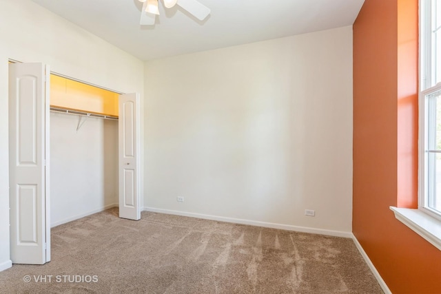 unfurnished bedroom featuring light carpet and baseboards