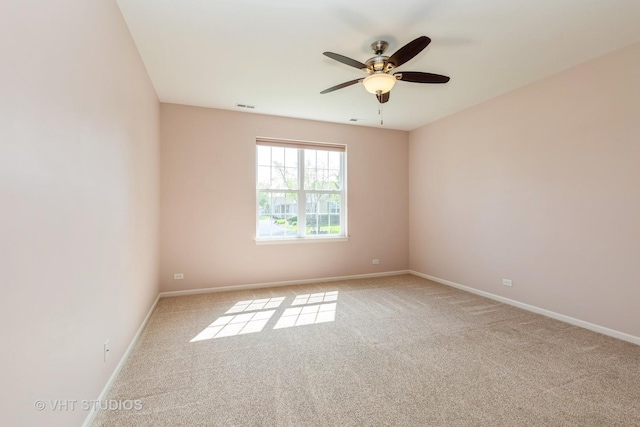 unfurnished room featuring carpet flooring, a ceiling fan, and baseboards