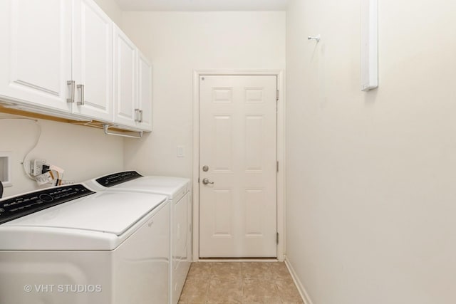 clothes washing area with cabinet space, washer and dryer, light tile patterned floors, and baseboards
