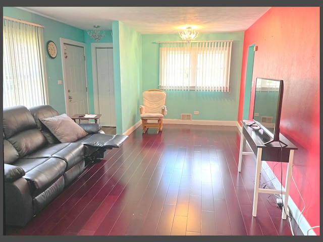 1908 Linden Ave, Waukegan, IL 60087 - living room with a chandelier, wood finished floors, and baseboards