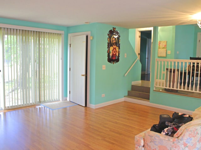 1908 Linden Ave, Waukegan, IL 60087 - living area with plenty of natural light, wood finished floors, stairway, and baseboards