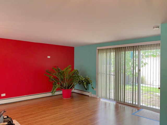1908 Linden Ave, Waukegan, IL 60087 - empty room with plenty of natural light, a smoke detector, wood finished floors, and baseboard heating