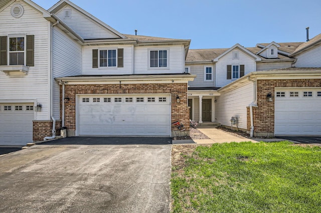 614 Grand Canyon Cir, Crystal Lake, IL 60014 - view of front of home with asphalt driveway, brick siding, and a garage