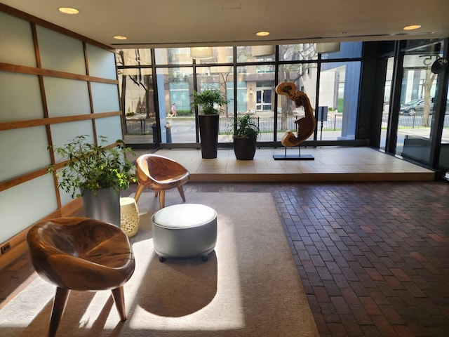 community lobby with floor to ceiling windows and recessed lighting