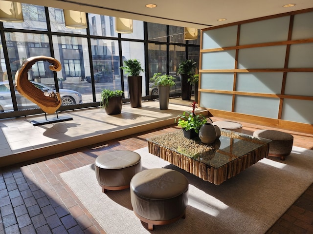 community lobby featuring a wall of windows and recessed lighting