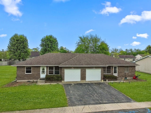 single story home with a garage, brick siding, a front yard, and driveway