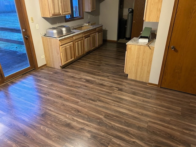 kitchen with dark wood-style floors, light countertops, and baseboards