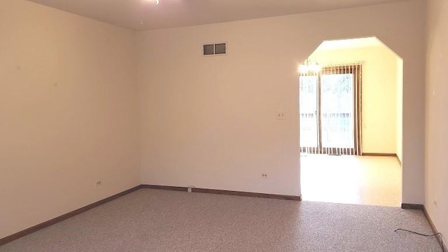 unfurnished room with baseboards
