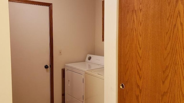 laundry area featuring washing machine and clothes dryer