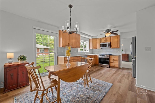 505 Waubonsee Trl, Batavia, IL 60510 - dining room with light wood finished floors, ceiling fan, and a chandelier